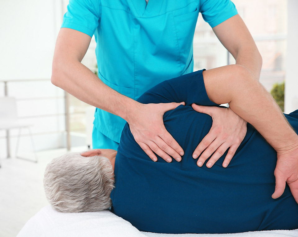 osteopath working with patient in clinic
