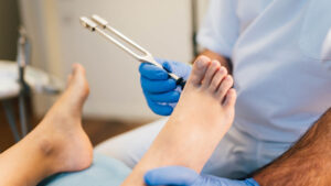 Podiatrist examining the foot of a patient in the medical centre